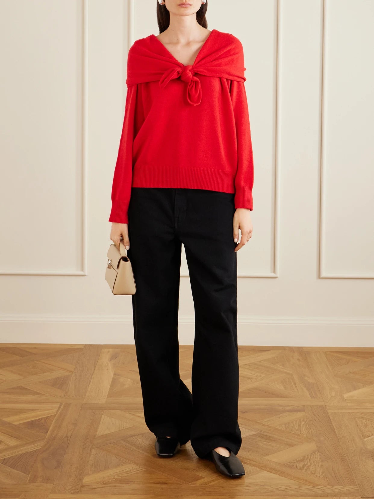 Image of a model wearing Outerwear. Product name - Malia Knot-detailed Cashmere Sweater in Red colour by brand - TOVE