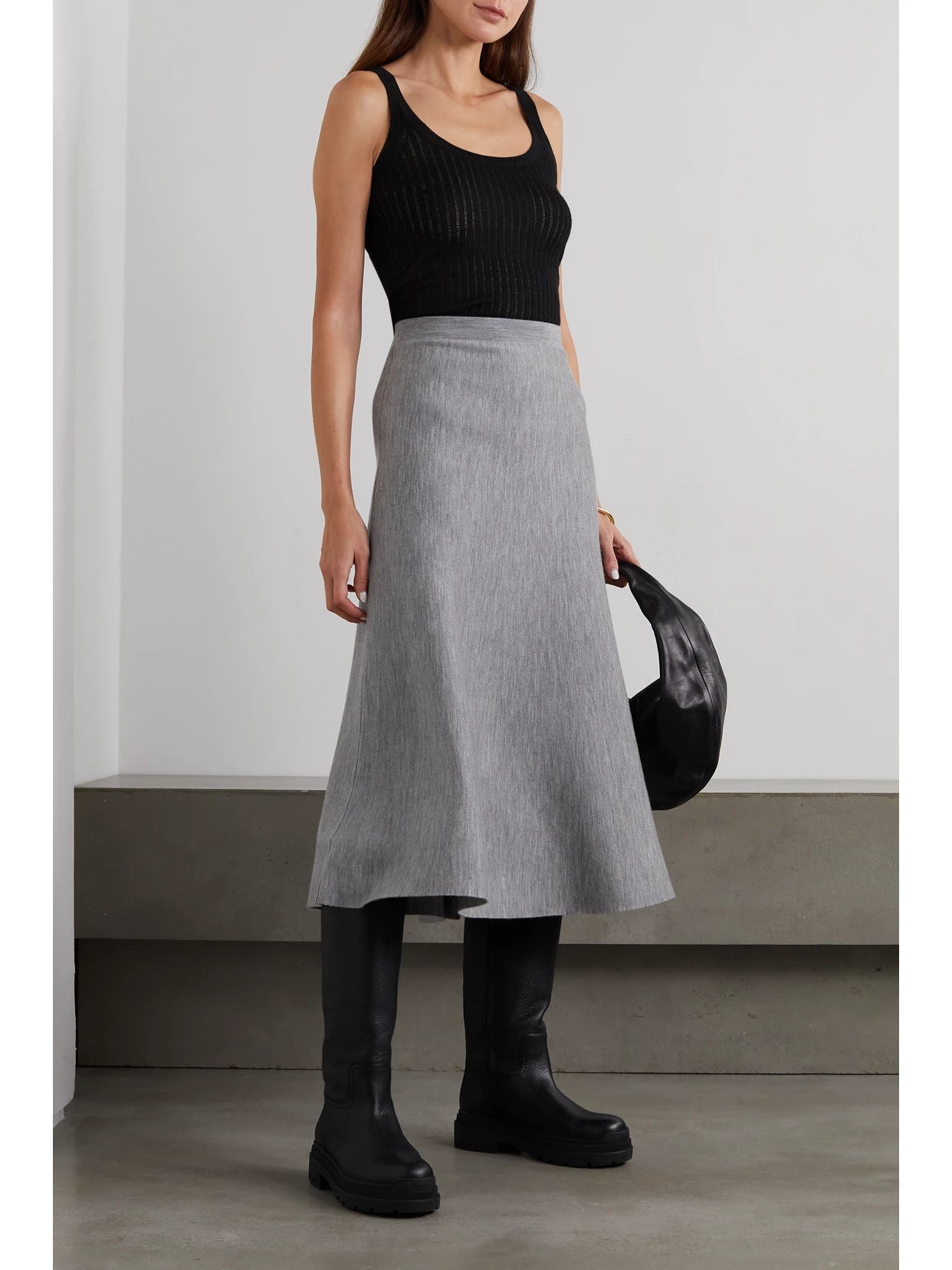 Image of a model wearing Tops. Product name - Nevin Pointelle-knit Cashmere And Silk-blend Tank in Black colour by brand - Gabriela Hearst