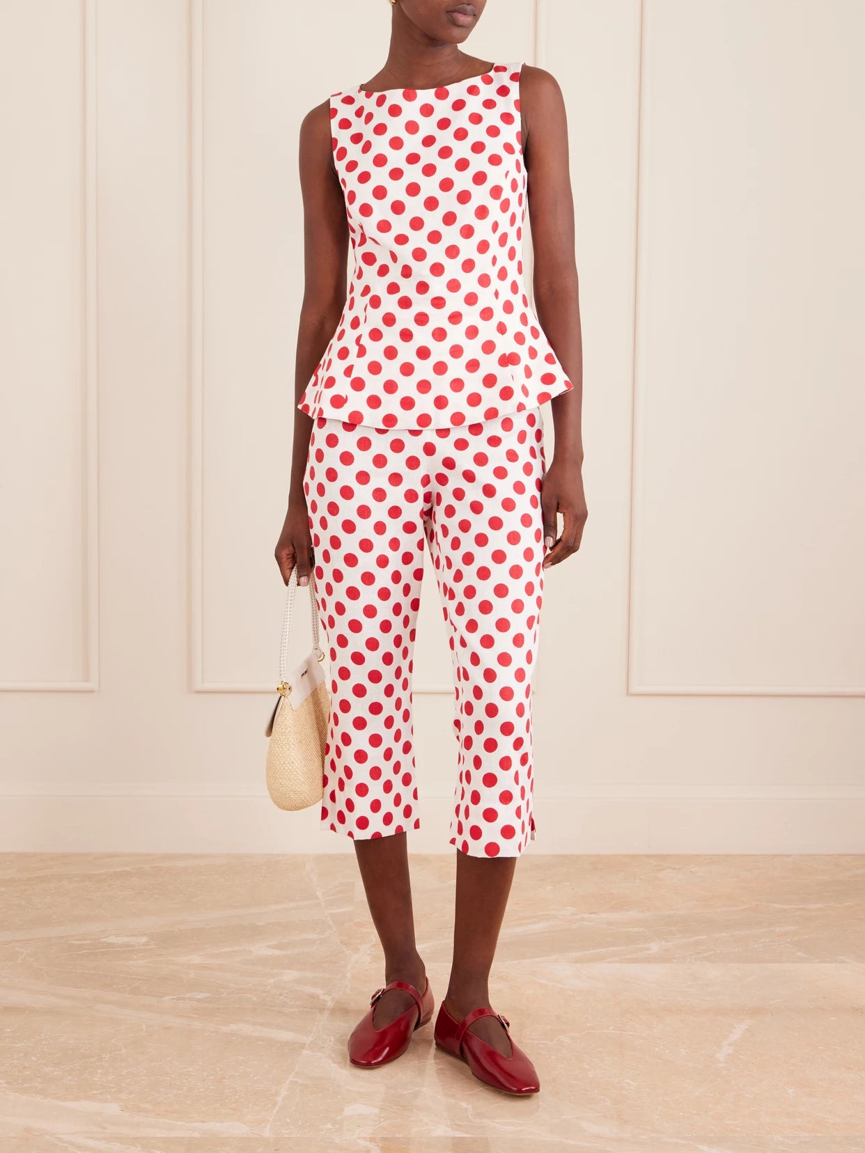 Image of a model wearing Pants. Product name - Valeria Capri Polka-dot Linen Pants in Red colour by brand - Faithfull