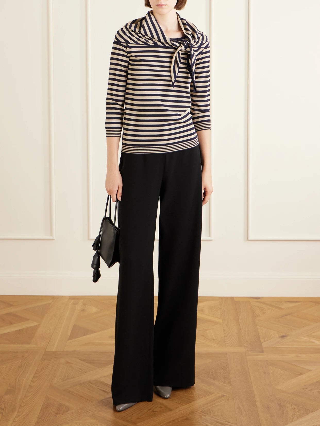 Image of a model wearing Pants. Product name - Crepe Wide-leg Pants in Black colour by brand - Max Mara
