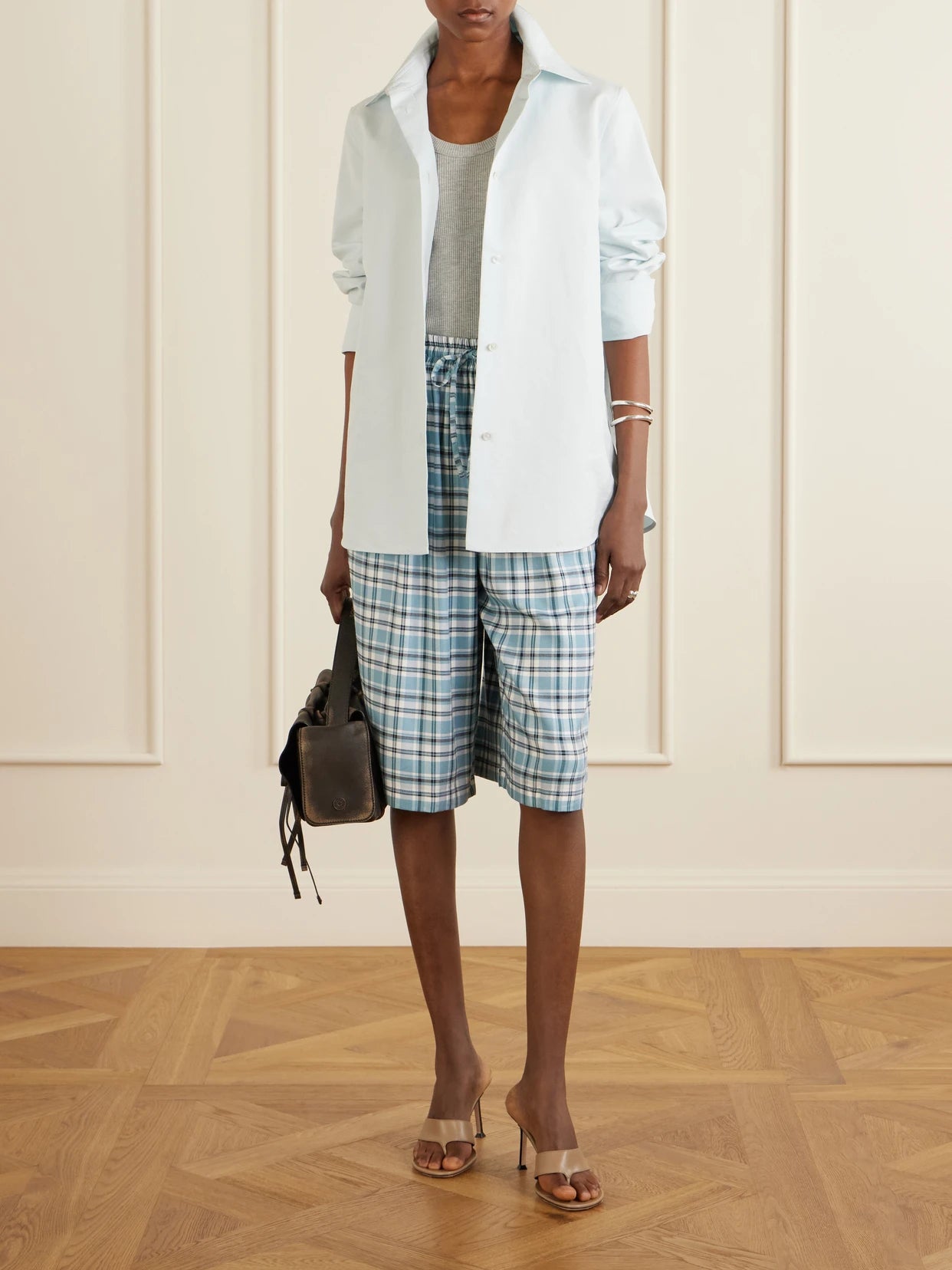 Image of a model wearing Shorts. Product name - Embroidered Checked Flannel Shorts in Blue colour by brand - Acne Studios
