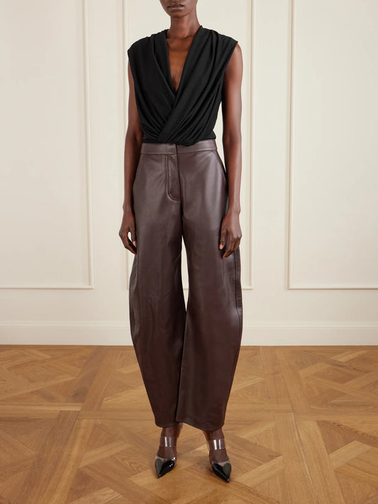 Image of a model wearing Tops. Product name - Hooded Draped Jersey Bodysuit in Black colour by brand - Alaïa