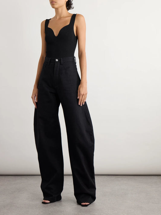 Image of a model wearing Tops. Product name - Ribbed Jersey Bodysuit in Black colour by brand - Alaïa