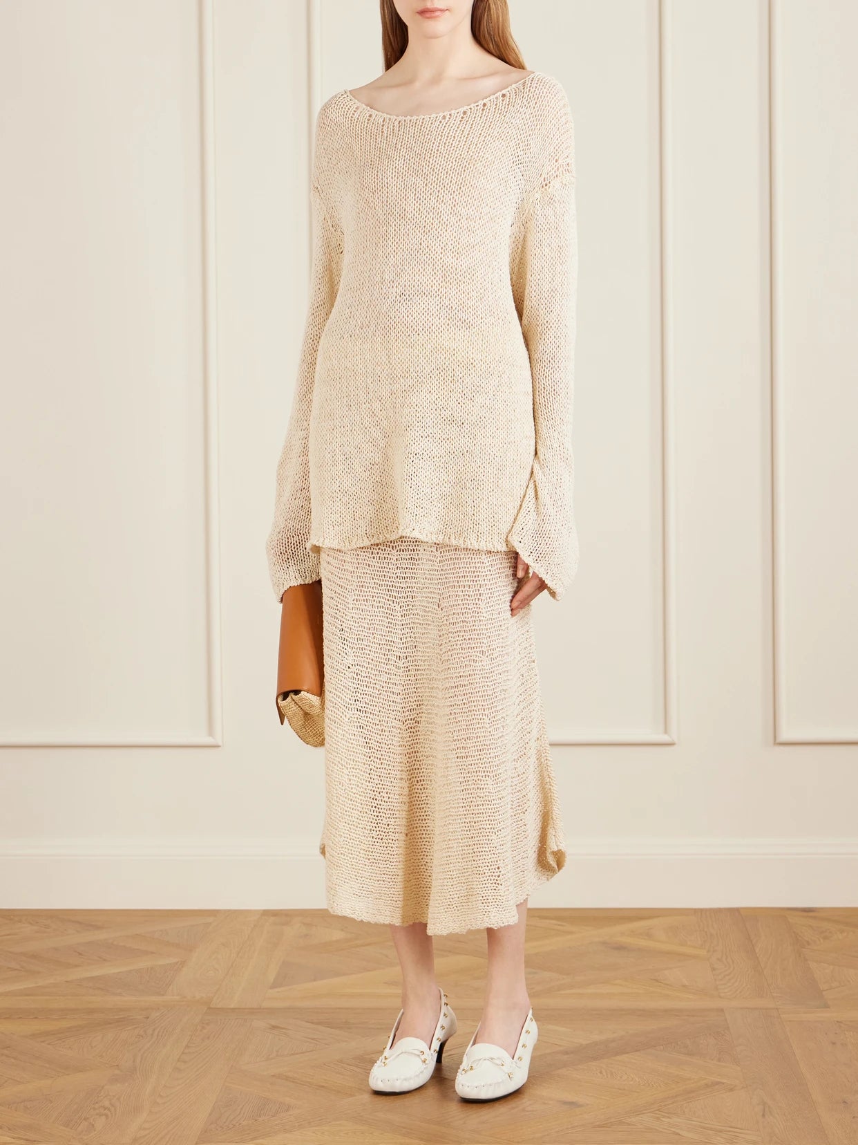 Image of a model wearing Outerwear. Product name - Davet Open-knit Silk And Cotton-blend Sweater in Ivory colour by brand - KHAITE