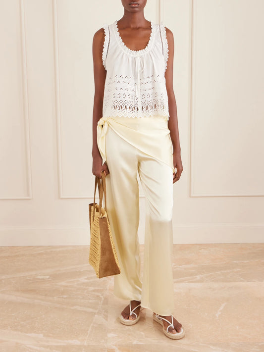 Image of a model wearing Pants. Product name - Lavona Tie-detailed Silk-satin Wide-leg Pants in Yellow colour by brand - DÔEN