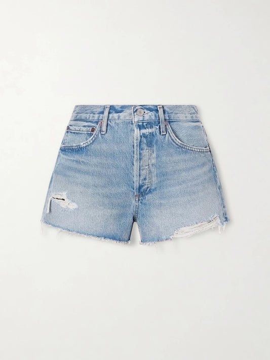 Image of a model wearing Shorts. Product name - Parker Distressed Denim Shorts in Light denim colour by brand - AGOLDE
