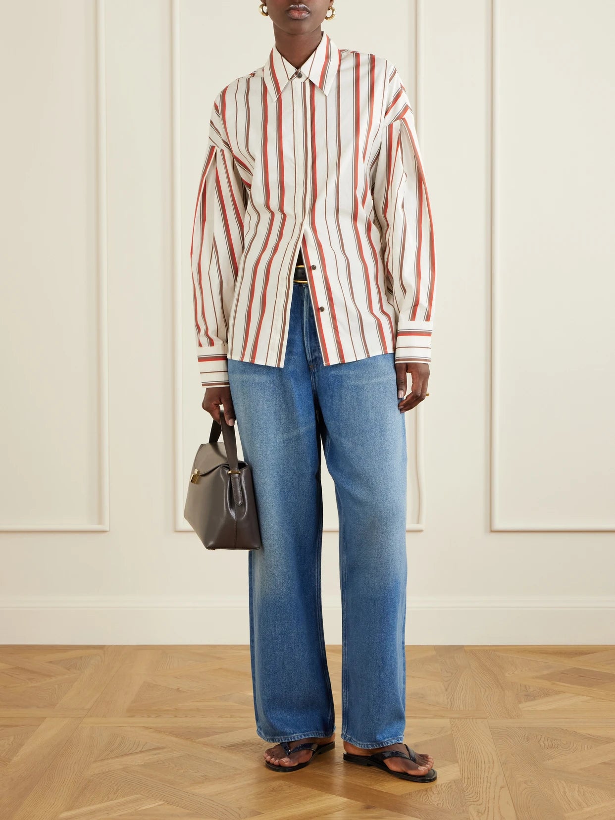 Image of a model wearing Tops. Product name - Alva Striped Cotton-poplin Shirt in Cream colour by brand - SIR.