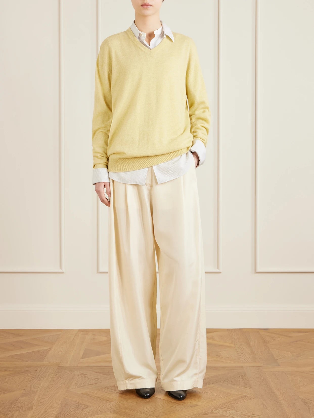 Image of a model wearing Pants. Product name - Kolina Pleated Silk-faille Wide-leg Pants in Pastel yellow colour by brand - The Row
