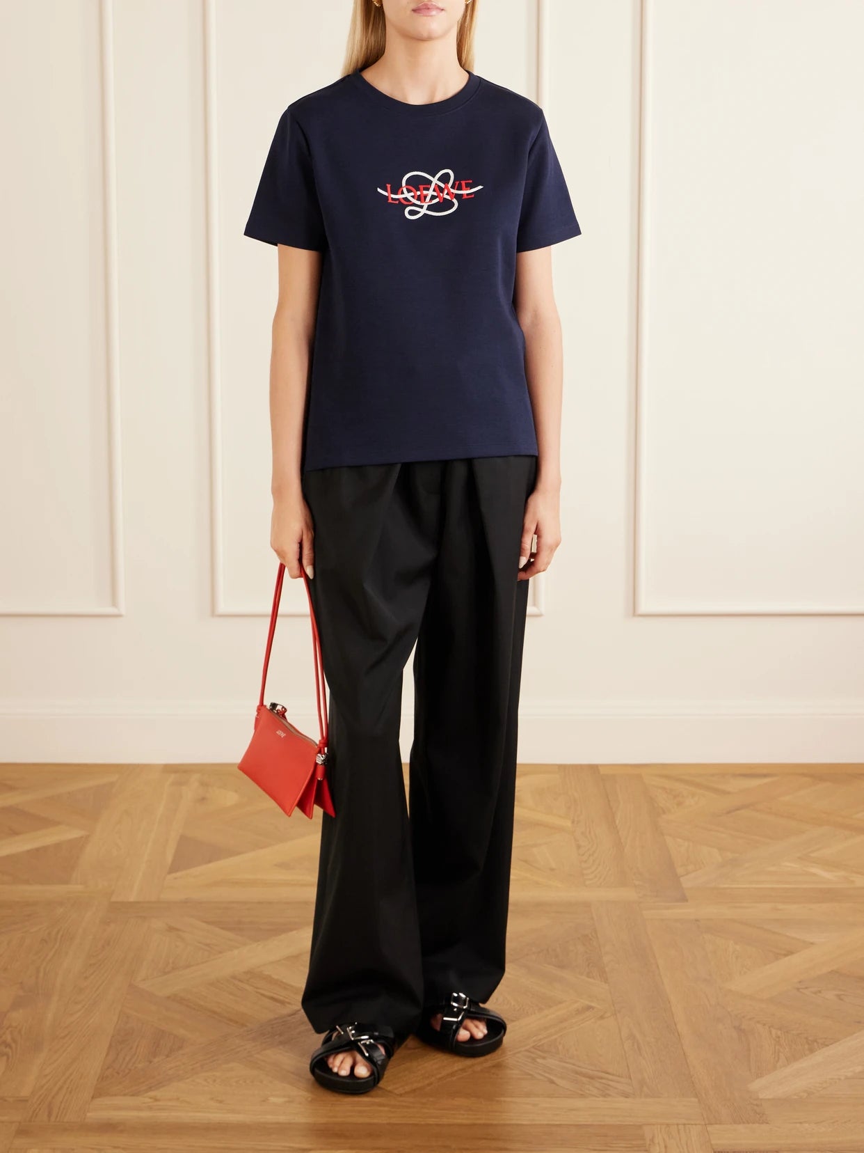 Image of a model wearing Tops. Product name - Anagram-embroidered Cotton-blend T-shirt in Navy colour by brand - LOEWE