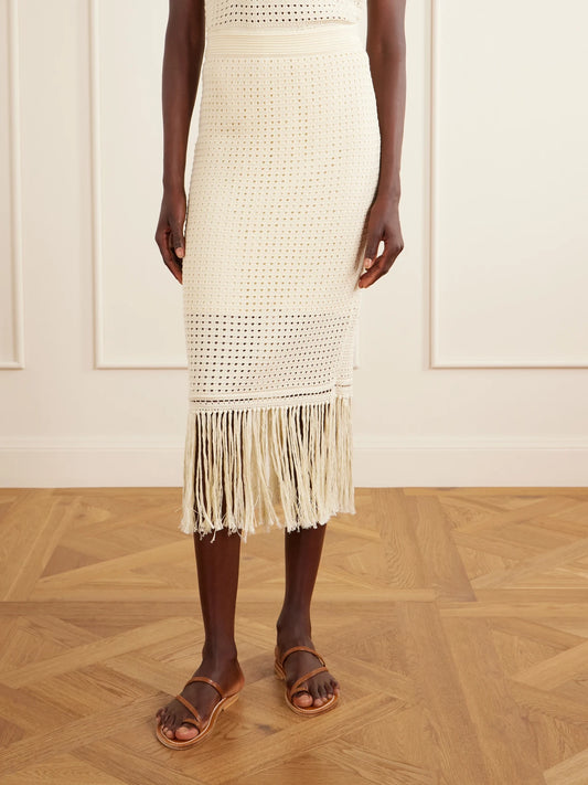 Image of a model wearing Skirts. Product name - Indra Fringed Crocheted Cotton Maxi Skirt in Cream colour by brand - Zimmermann