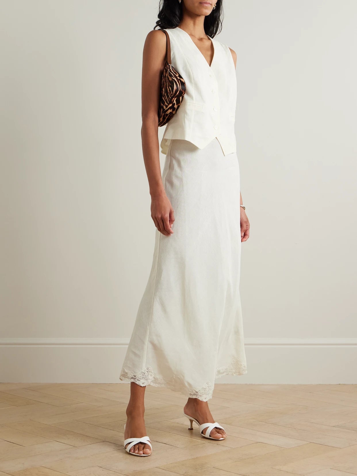 Image of a model wearing Skirts. Product name - Crystal Lace-trimmed Linen-blend Midi Skirt in Cream colour by brand - RIXO