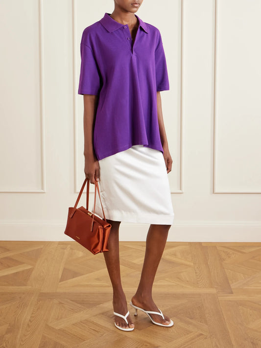 Image of a model wearing Tops. Product name - Julie Organic Cotton-piqué Polo Shirt in Purple colour by brand - FLORE FLORE