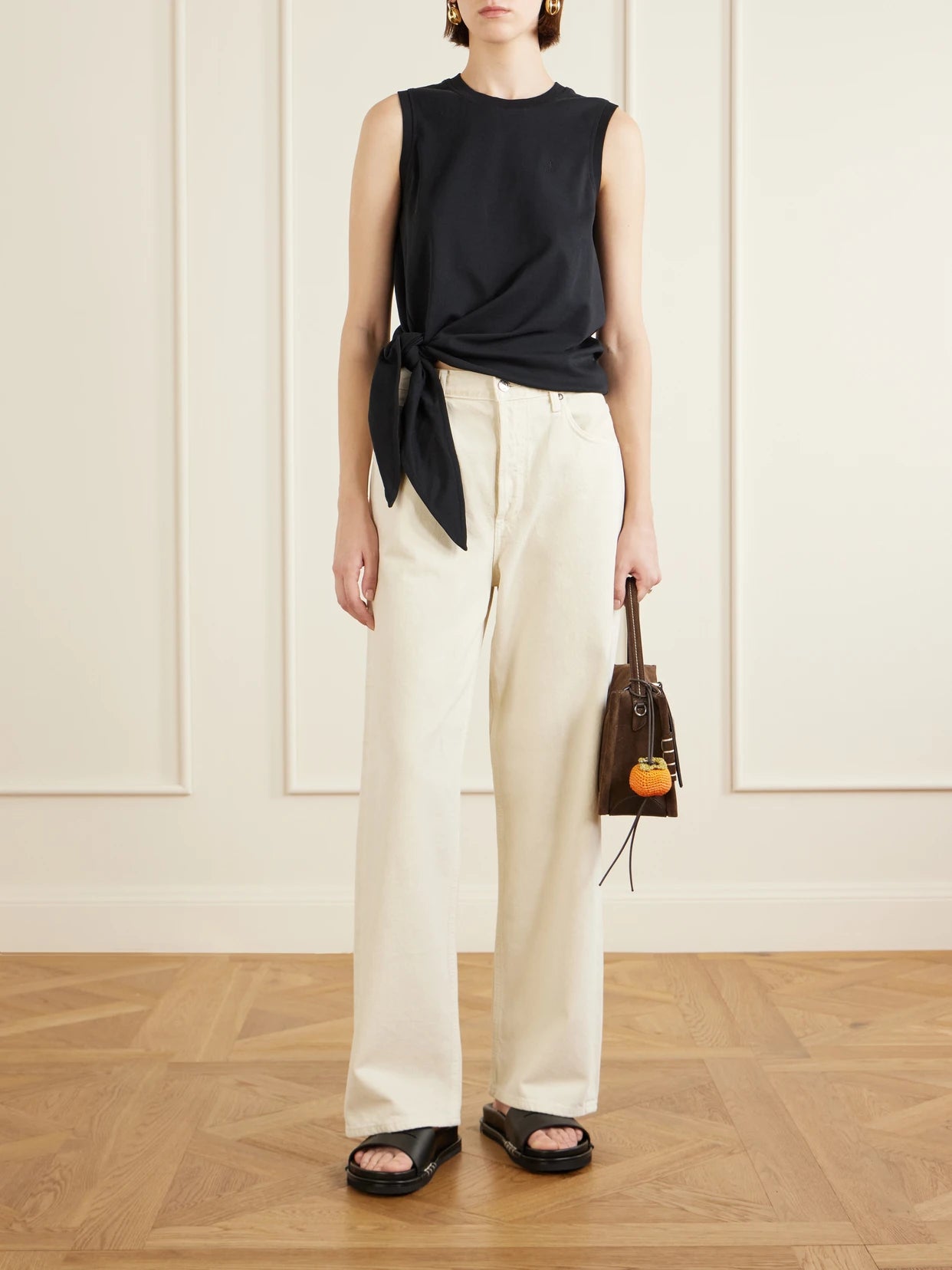 Image of a model wearing Tops. Product name - Tie-detailed Logo-embroidered Cotton-jersey Tank in Black colour by brand - JW Anderson