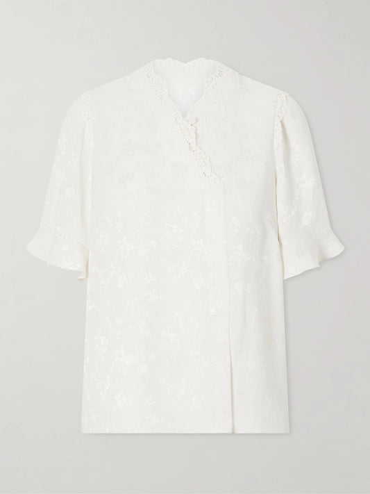 Image of a model wearing Tops. Product name - Margarita Mesh And Crochet-trimmed Floral-jacquard Silk-crepe Blouse in Ivory colour by brand - MAISON MAYLE