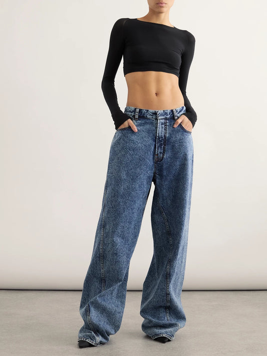 Image of a model wearing Tops. Product name - Paneled Cropped Jersey Top in Black colour by brand - Alaïa