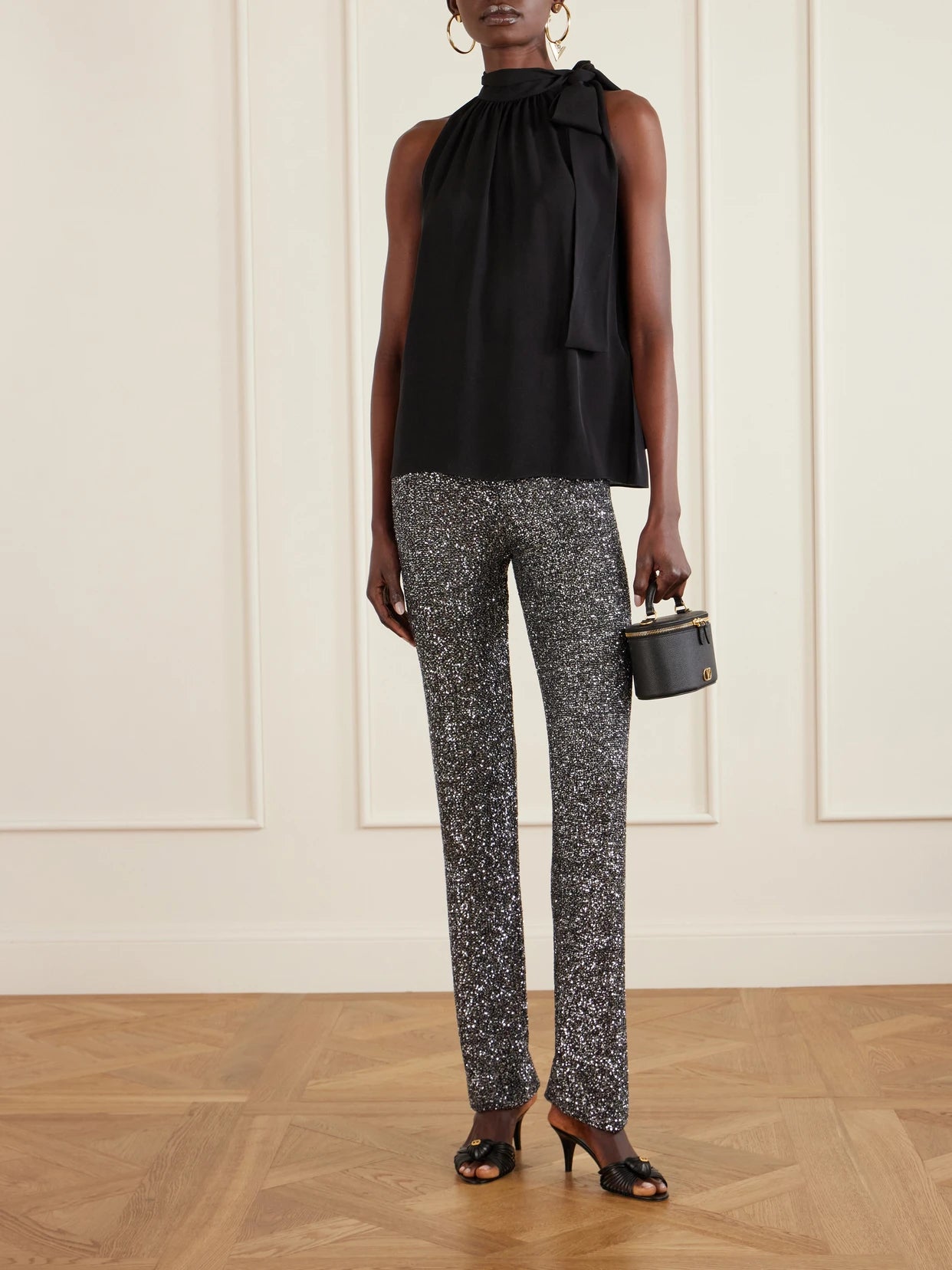 Image of a model wearing Pants. Product name - Sequined Knitted Straight-leg Pants in Black colour by brand - Valentino Garavani