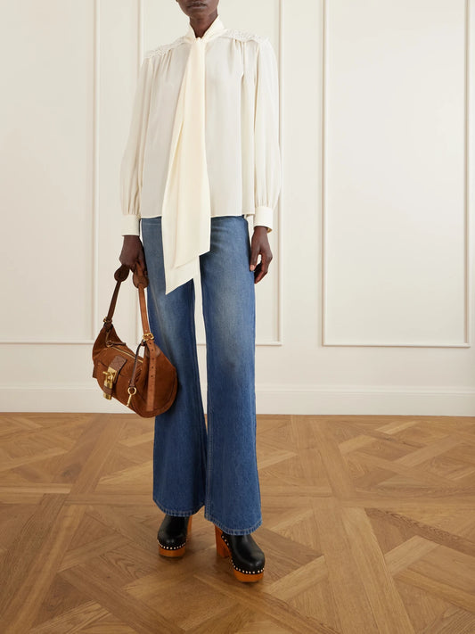 Image of a model wearing Tops. Product name - Pussy-bow Crochet-trimmed Silk Crepe De Chine Shirt in White colour by brand - Chloé