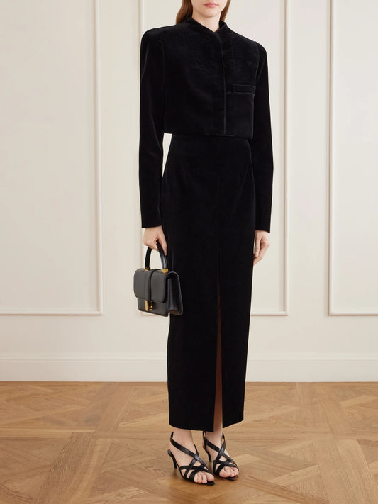 Image of a model wearing Skirts. Product name - Lachlan Velvet Cotton-blend Midi Skirt in Black colour by brand - KHAITE