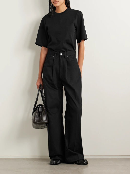 Image of a model wearing Tops. Product name - The Isla Organic Cotton-jersey T-shirt in Black colour by brand - RÙADH