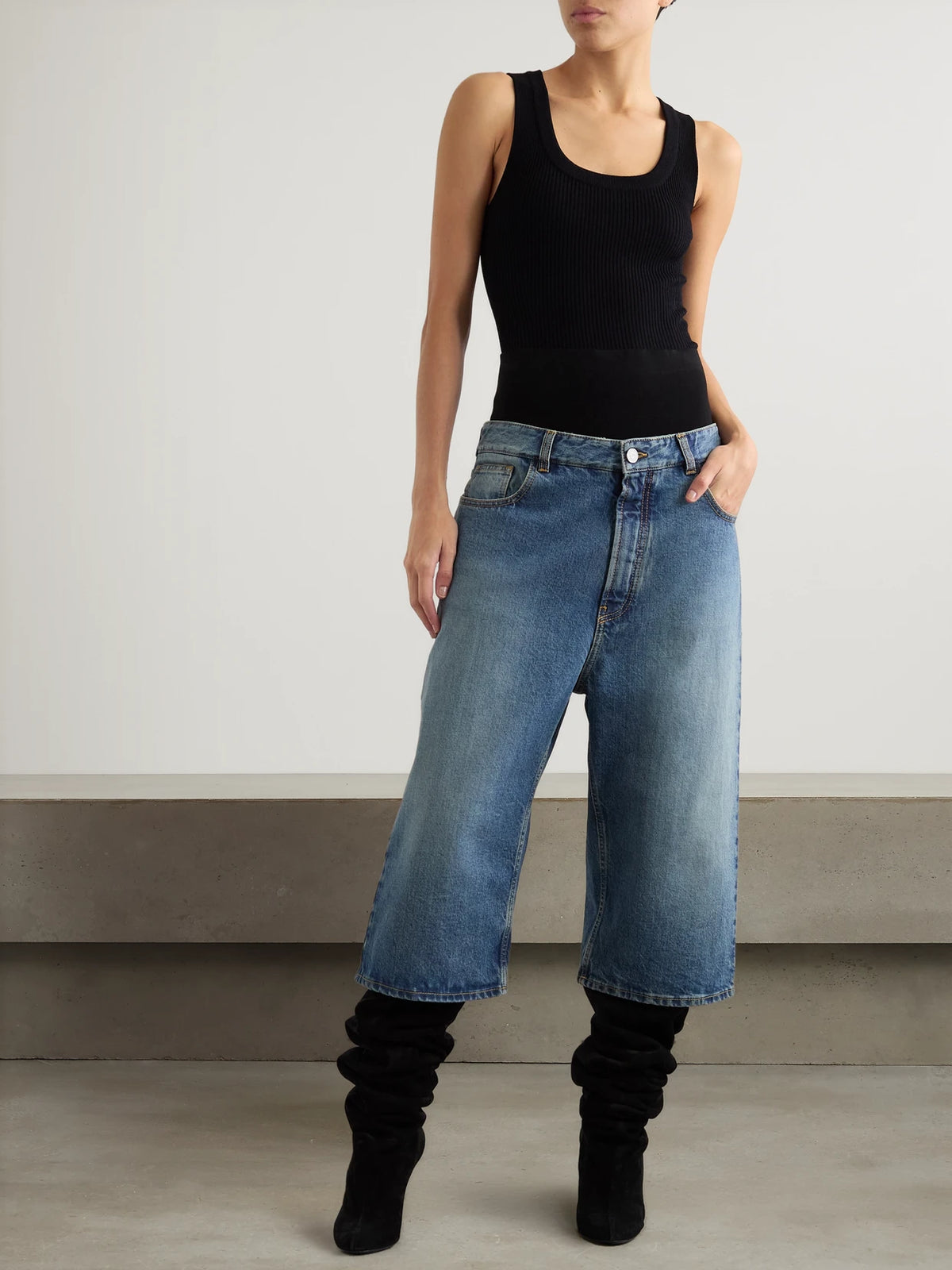 Image of a model wearing Shorts. Product name - Jersey-trimmed Denim Shorts in Blue colour by brand - Alaïa