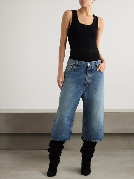 Image of a model wearing Shorts. Product name - Jersey-trimmed Denim Shorts in Blue colour by brand - Alaïa