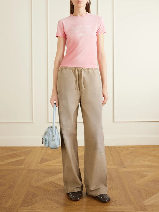 Image of a model wearing Tops. Product name - Etza 1996 Logo-printed Cotton And Hemp-blend T-shirt in Pink colour by brand - Acne Studios