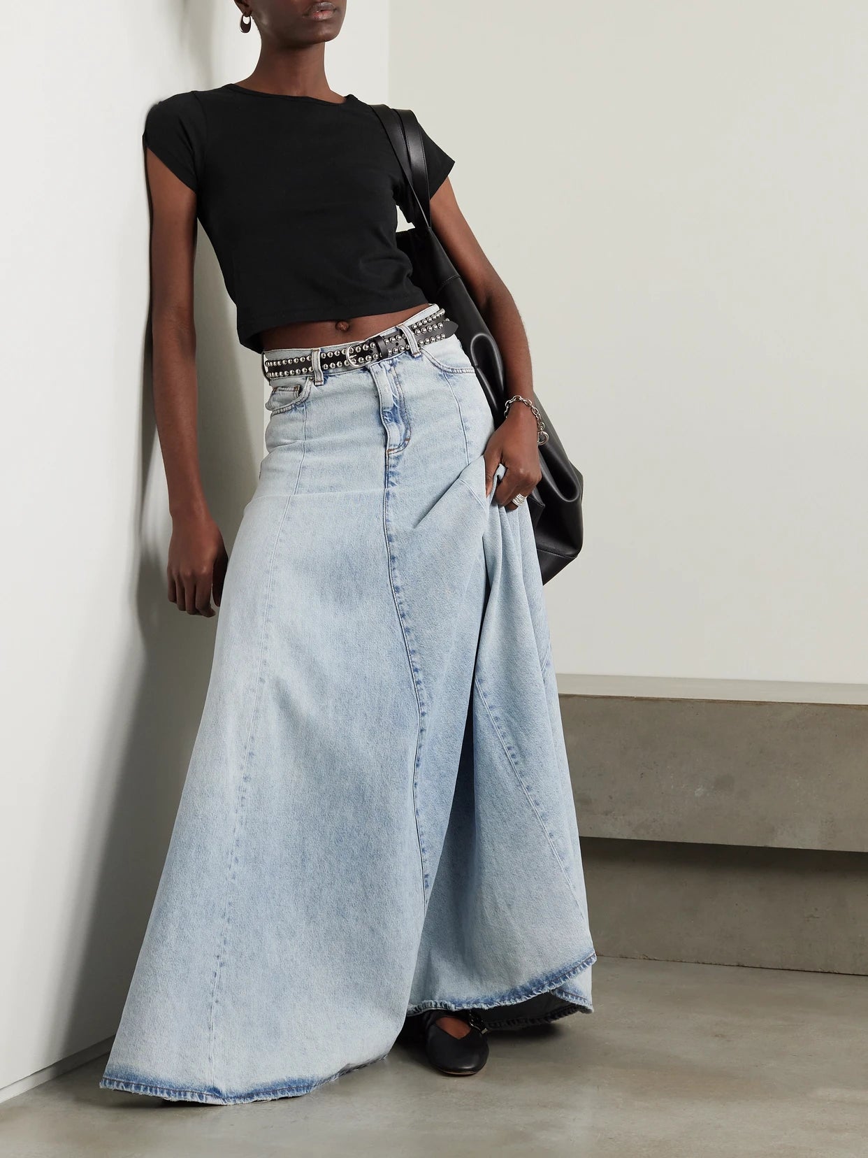 Image of a model wearing Tops. Product name - Short Sleeve Baby Tee Cropped Cotton And Modal-blend Jersey T-shirt in Black colour by brand - ÉTERNE