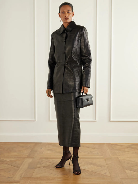 Image of a model wearing Skirts. Product name - Elyse Paneled Croc-effect Leather Midi Skirt in Black colour by brand - Nour Hammour