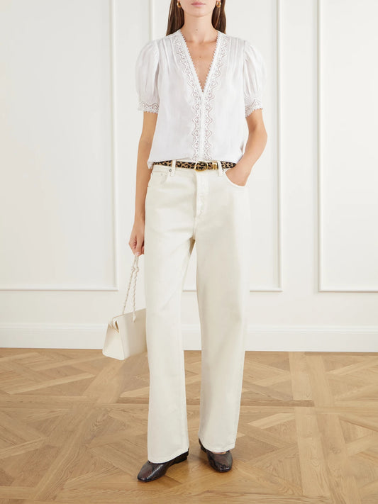 Image of a model wearing Tops. Product name - Brigitta Lace-trimmed Pintucked Ramie Woven Blouse in Off-white, Black colour by brand - DÔEN