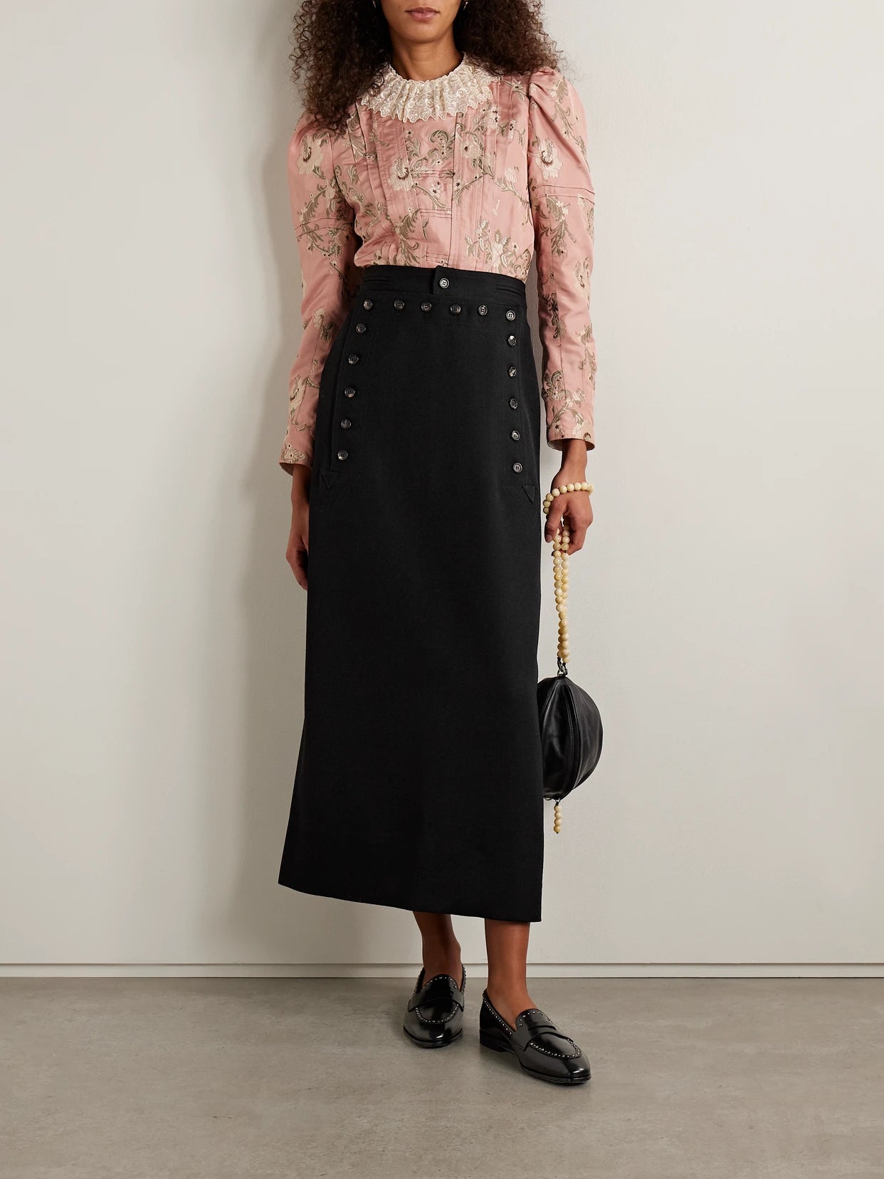 Image of a model wearing Skirts. Product name - Wool-twill Maxi Skirt in Black colour by brand - BODE