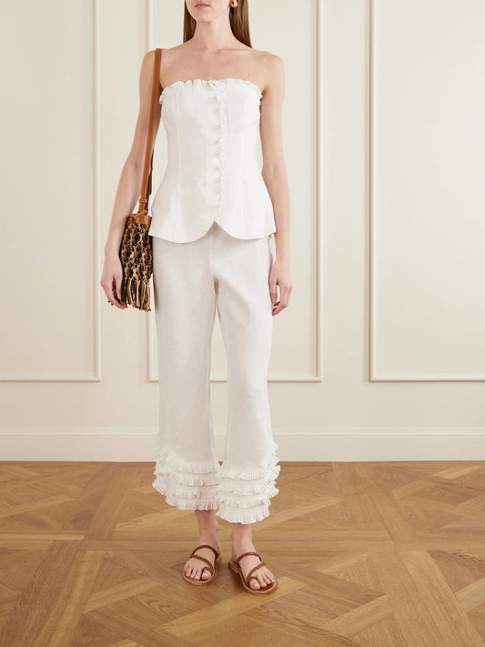 Image of a model wearing Tops. Product name - Florence Strapless Ruffled Linen Top in White colour by brand - Posse