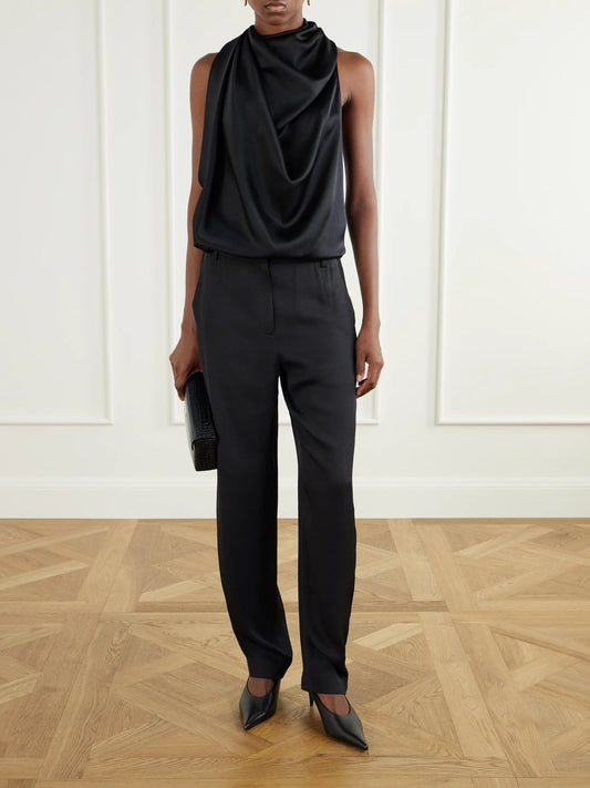 Image of a model wearing Pants. Product name - Grace Satin-twill Tapered Pants in Black, Mustard colour by brand - Tibi