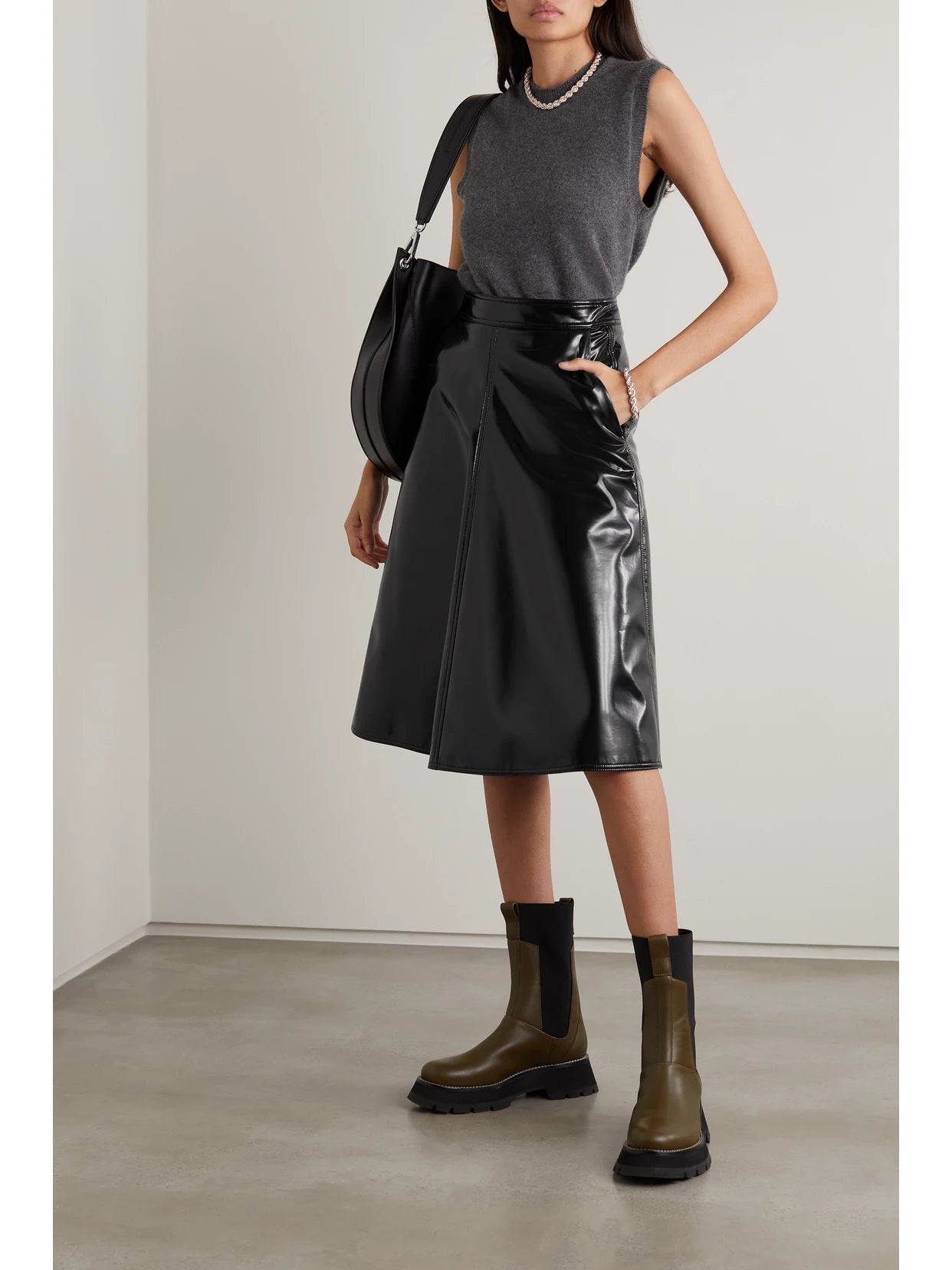 Image of a model wearing Skirts. Product name - + 1952 Pvc Midi Skirt in Black colour by brand - Moncler Genius