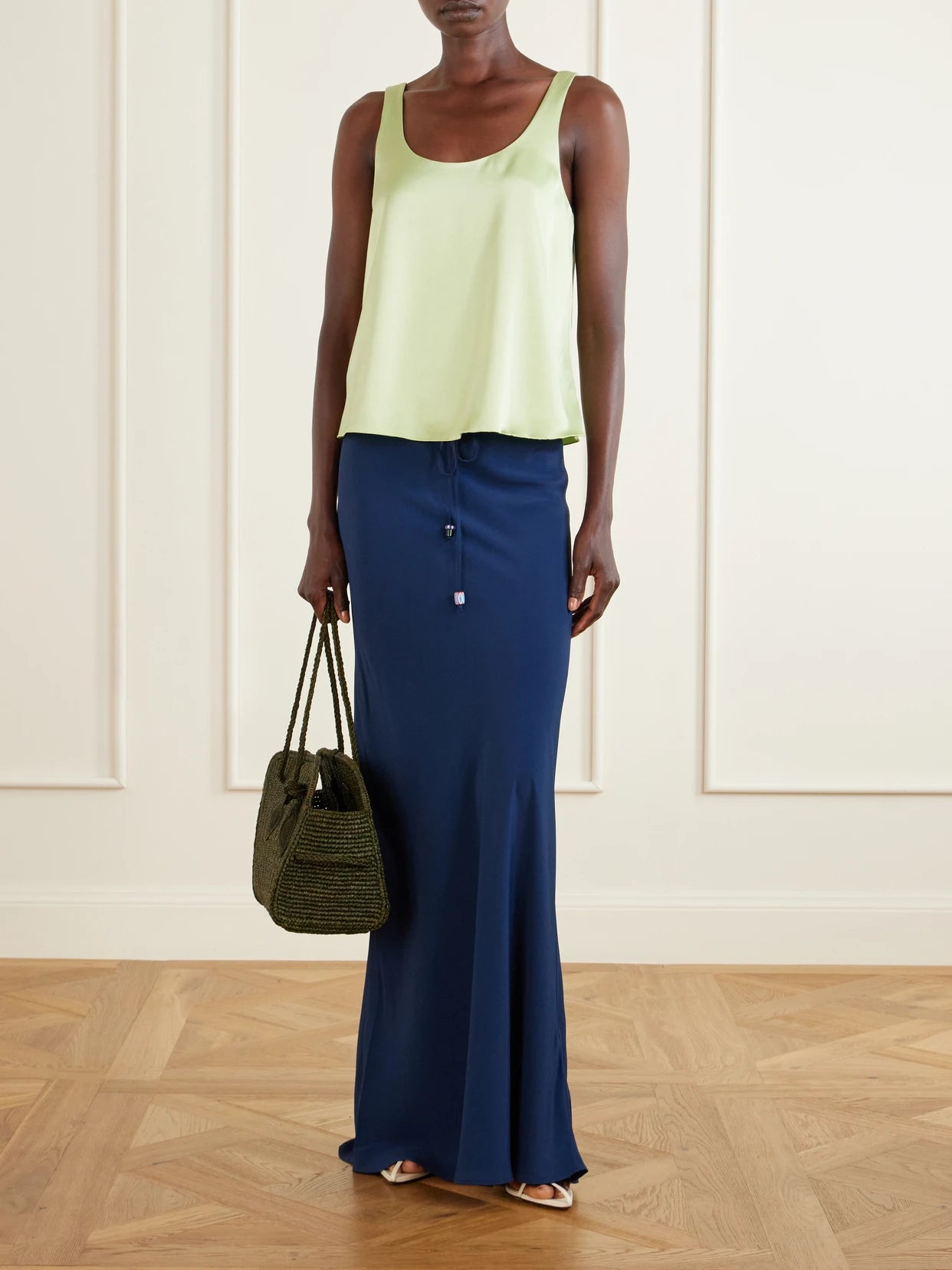 Image of a model wearing Skirts. Product name - Emily Satin Maxi Skirt in Navy colour by brand - BERNADETTE