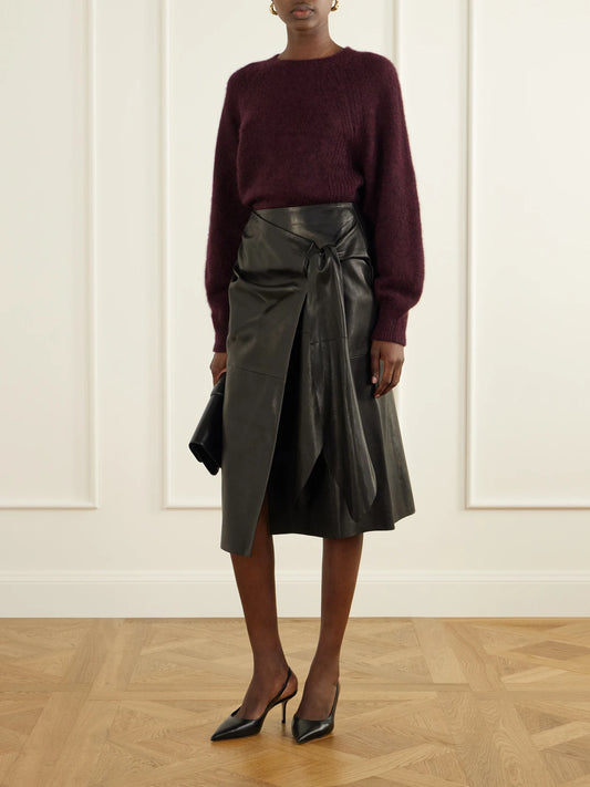 Image of a model wearing Skirts. Product name - Viret Knotted Paneled Leather Midi Skirt in Black colour by brand - Nour Hammour