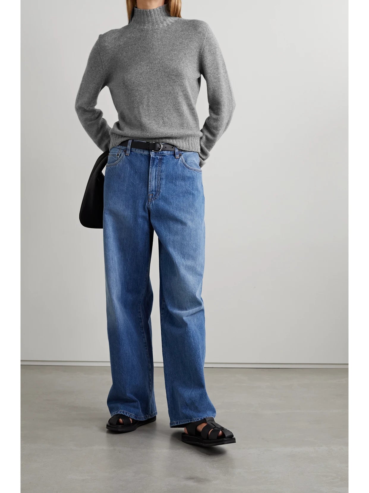 Image of a model wearing Outerwear. Product name - Essentials Kensington Cashmere Turtleneck Sweater in Gray colour by brand - The Row