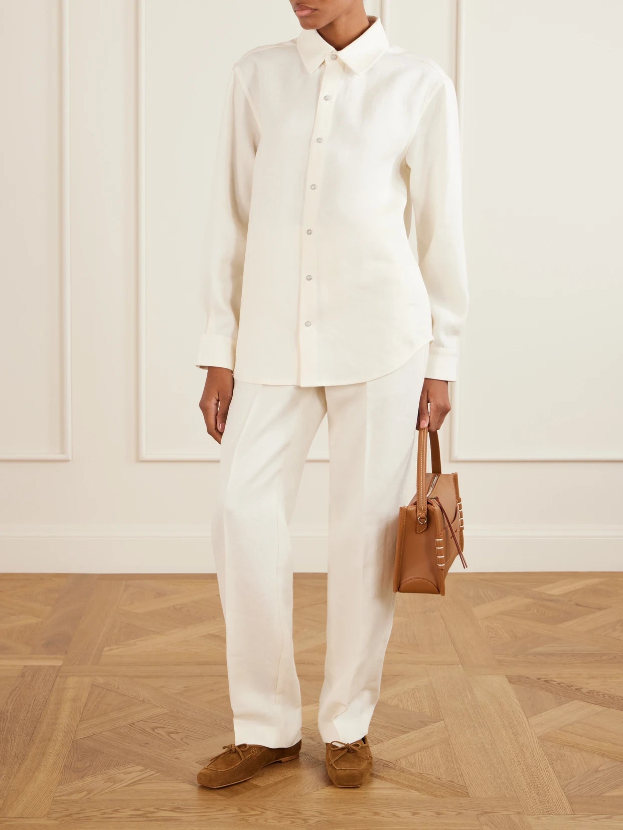 Image of a model wearing Pants. Product name - Solid Linen Straight-leg Pants in Ivory colour by brand - God's True Cashmere