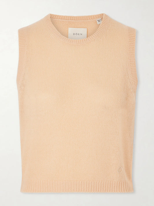 Image of a model wearing Outerwear. Product name - Louden Cashmere Vest in Peach colour by brand - DÔEN