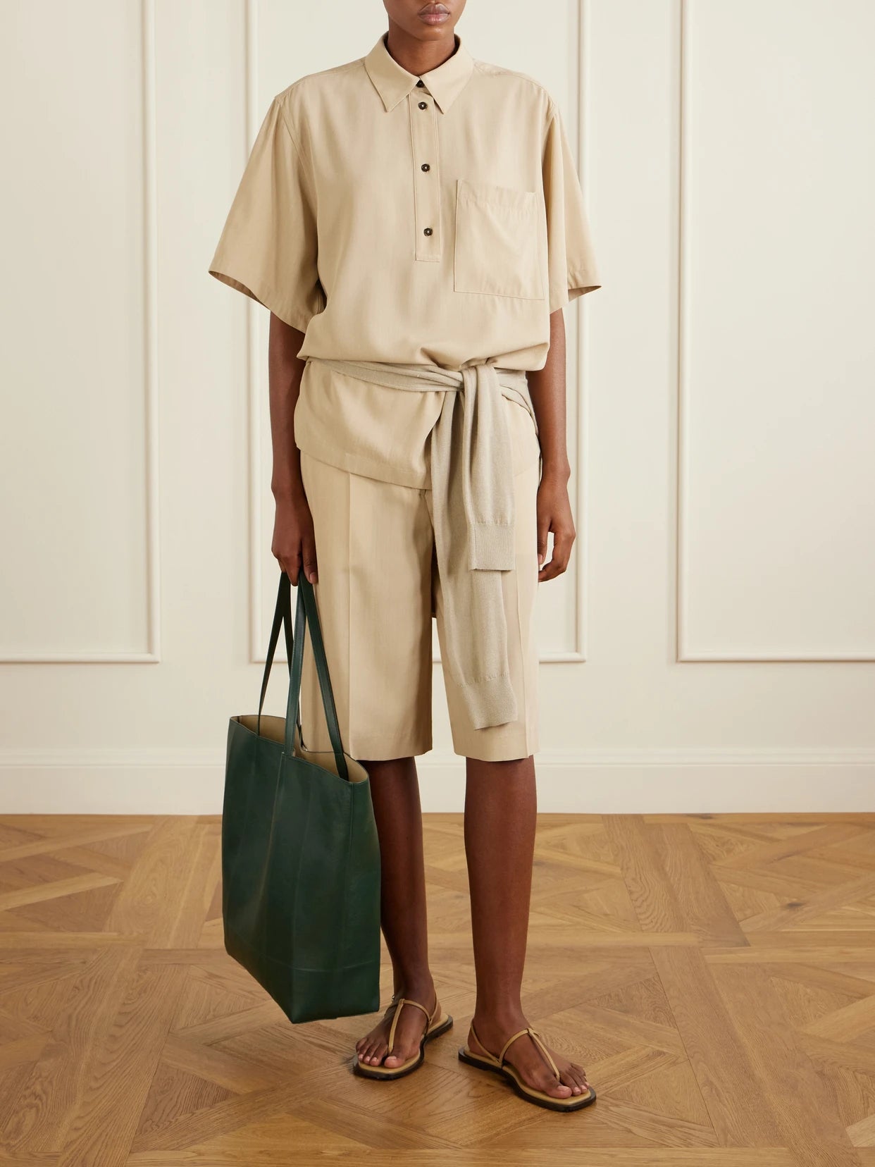 Image of a model wearing Shorts. Product name - Woven Shorts in Beige colour by brand - TOTEME