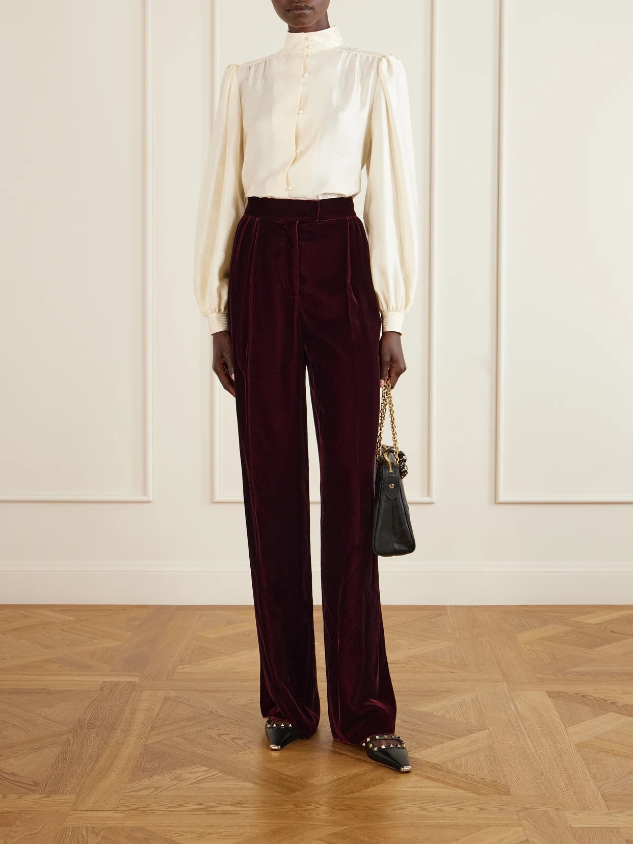Image of a model wearing Pants. Product name - Pleated Velvet Wide-leg Pants in Burgundy colour by brand - Valentino Garavani