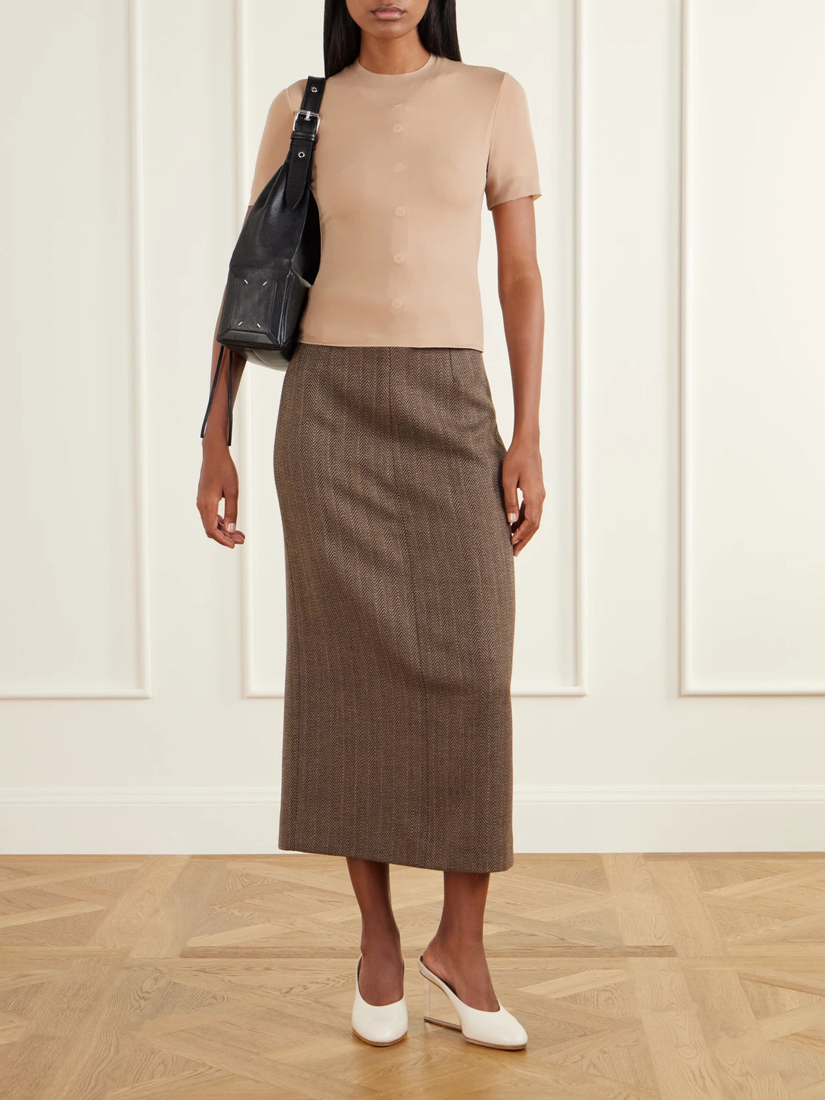 Image of a model wearing Skirts. Product name - Wool-herringbone Midi Skirt in Beige colour by brand - Maison Margiela