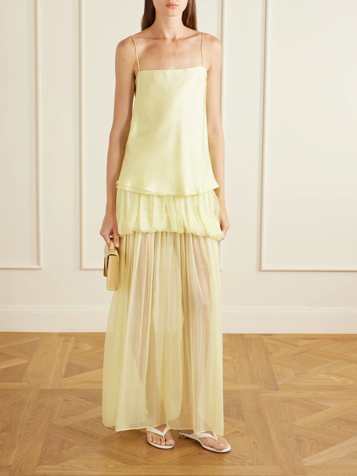 Image of a model wearing Skirts. Product name - Silk-chiffon Maxi Skirt in Pastel yellow colour by brand - LIBEROWE