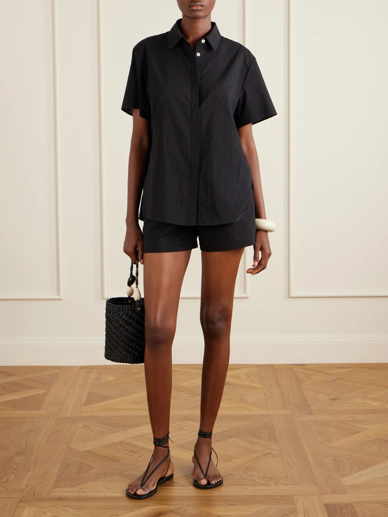 Image of a model wearing Tops. Product name - Cotton Shirt in Black colour by brand - Lido