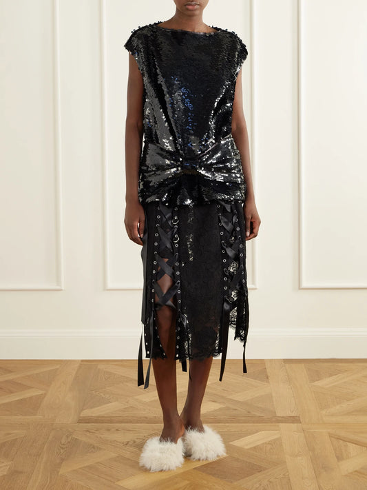 Image of a model wearing Tops. Product name - Bow-detail Sequin-embellished Mesh Blouse in Black colour by brand - Simone Rocha