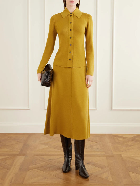 Image of a model wearing Skirts. Product name - Dorian Ribbed-knit Wool Midi Skirt in Mustard colour by brand - Emilia Wickstead