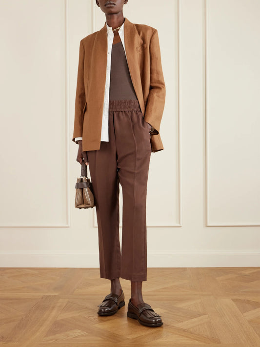 Image of a model wearing Pants. Product name - Cropped Woven Tapered Pants in Dark brown colour by brand - Brunello Cucinelli