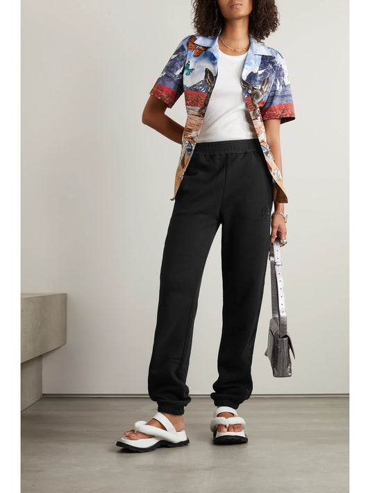 Image of Sleepwear & Loungewear. Product name - Embellished Shell-trimmed Cotton-jersey Track Pants in Black colour by brand - Moncler