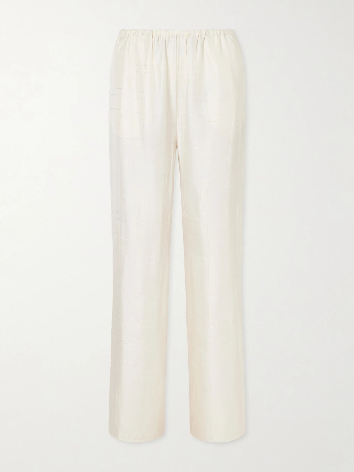 Image of a model wearing Pants. Product name - Monogram Silk Wide-leg Pyjama Pants in Cream colour by brand - TOTEME