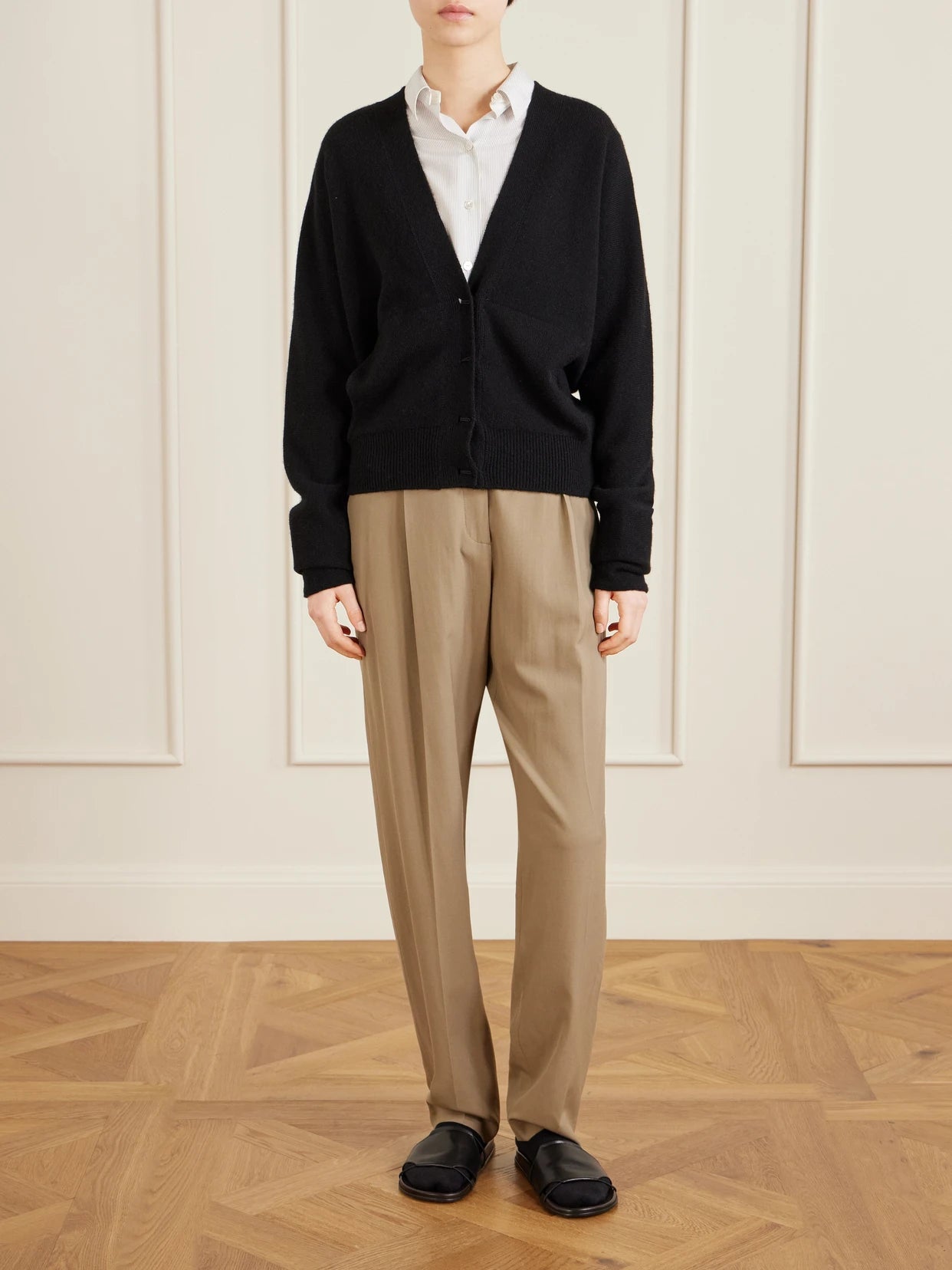 Image of a model wearing Outerwear. Product name - Navona Cashmere Cardigan in Black colour by brand - The Row