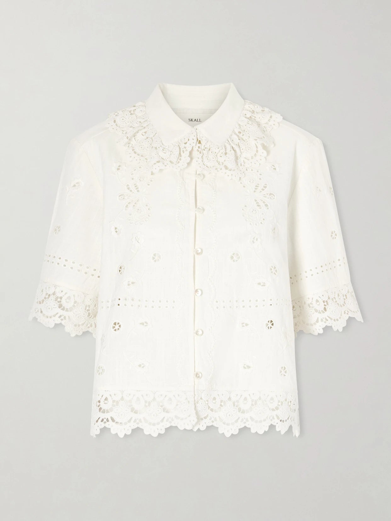 Image of a model wearing Tops. Product name - Talia Broderie Anglaise Cotton And Linen-blend Shirt in White colour by brand - SKALL